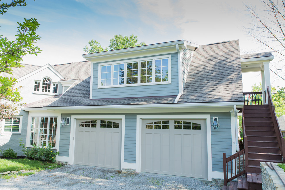Garage - large traditional attached two-car garage idea in Louisville