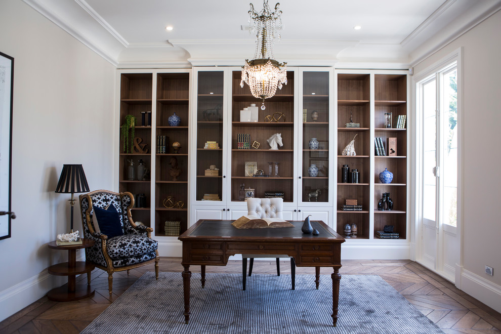 Traditional study room in Melbourne with beige walls, medium hardwood floors, a freestanding desk and brown floor.