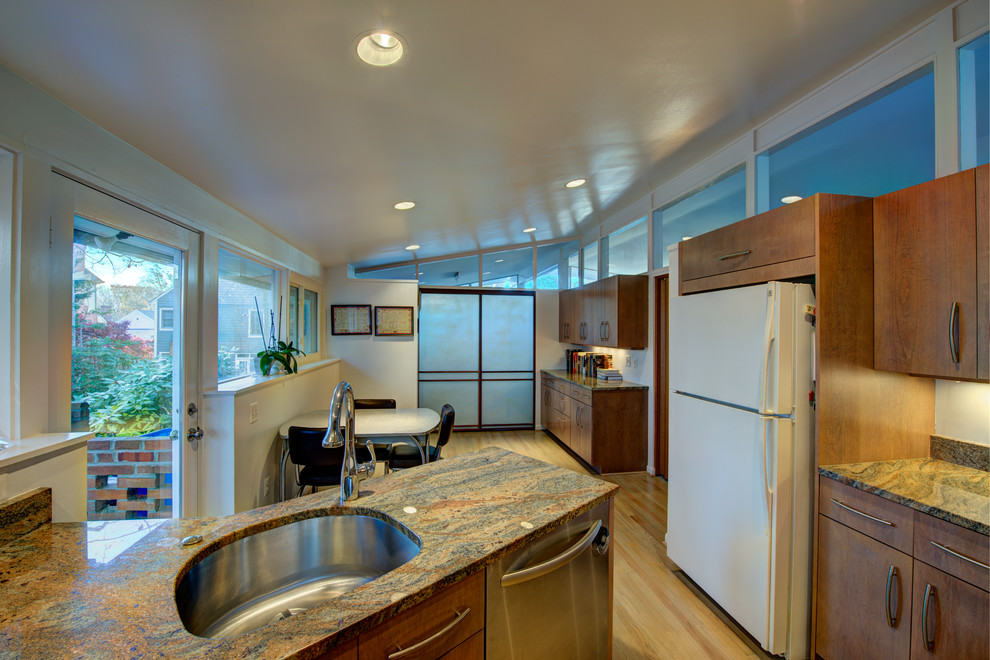 Eat-in kitchen - mid-sized transitional u-shaped light wood floor eat-in kitchen idea in DC Metro with medium tone wood cabinets, granite countertops, a peninsula, an undermount sink, flat-panel cabinets, beige backsplash, stone slab backsplash and white appliances