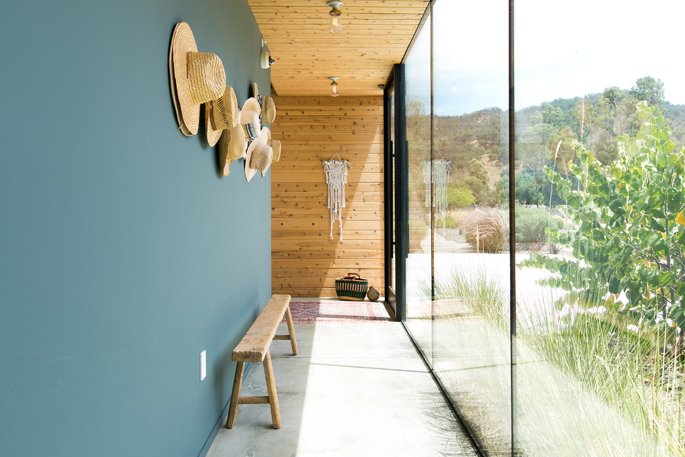 Country hallway in Los Angeles with blue walls, concrete floors and grey floor.