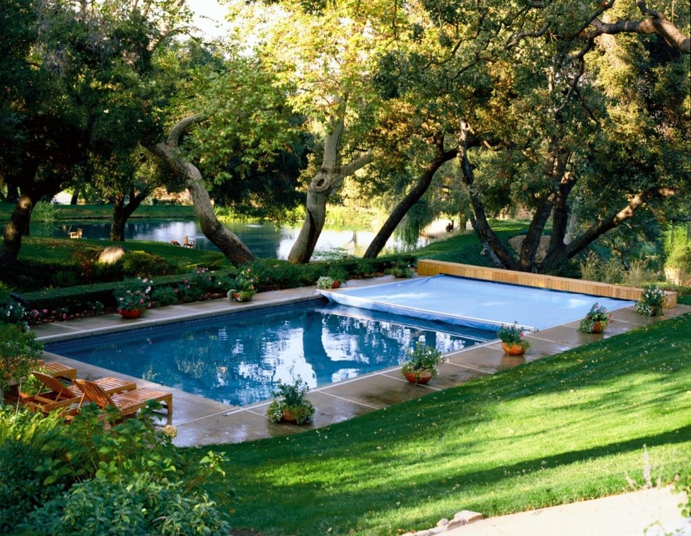 Design ideas for a large backyard rectangular lap pool in Richmond with natural stone pavers.