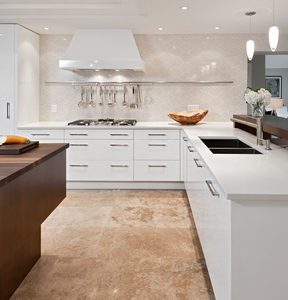 Design ideas for a contemporary u-shaped kitchen in Ottawa with a double-bowl sink, flat-panel cabinets, white cabinets, wood benchtops, beige splashback and travertine floors.