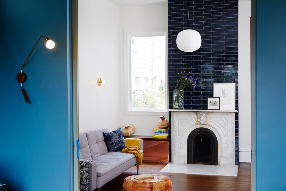 Eclectic living room in San Francisco with white walls, a standard fireplace and a tile fireplace surround.