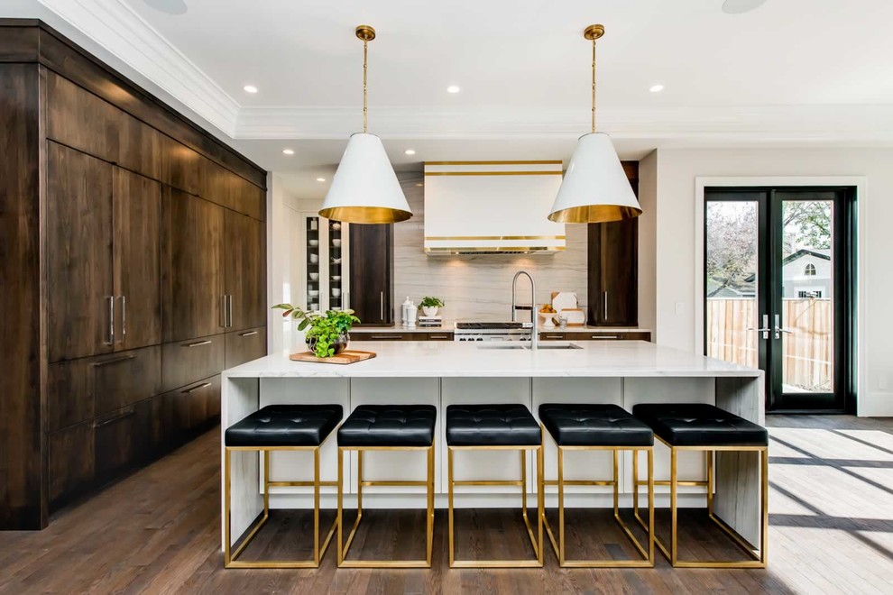 This is an example of a contemporary l-shaped kitchen in Vancouver with an undermount sink, flat-panel cabinets, dark wood cabinets, beige splashback, medium hardwood floors, with island, brown floor and white benchtop.