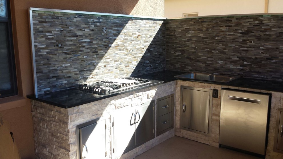 Photo of a large contemporary backyard patio in Jacksonville with an outdoor kitchen.