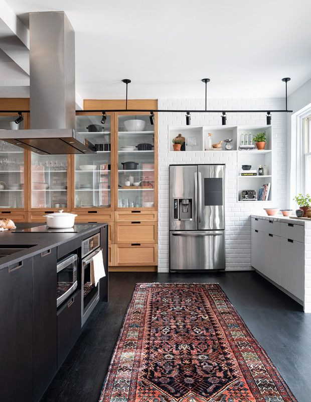 Expansive eclectic open plan kitchen in Columbus with an undermount sink, flat-panel cabinets, black cabinets, quartzite benchtops, white splashback, brick splashback, stainless steel appliances, linoleum floors, with island, black floor and grey benchtop.