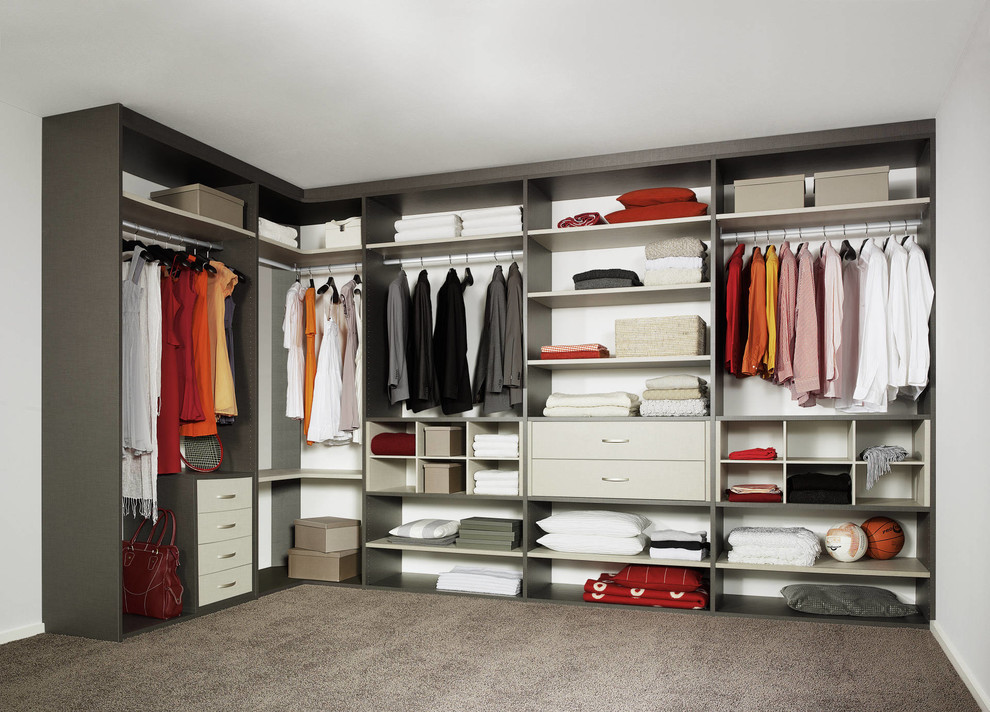 This is an example of a large scandinavian gender-neutral walk-in wardrobe in Moscow with glass-front cabinets, laminate floors and beige floor.