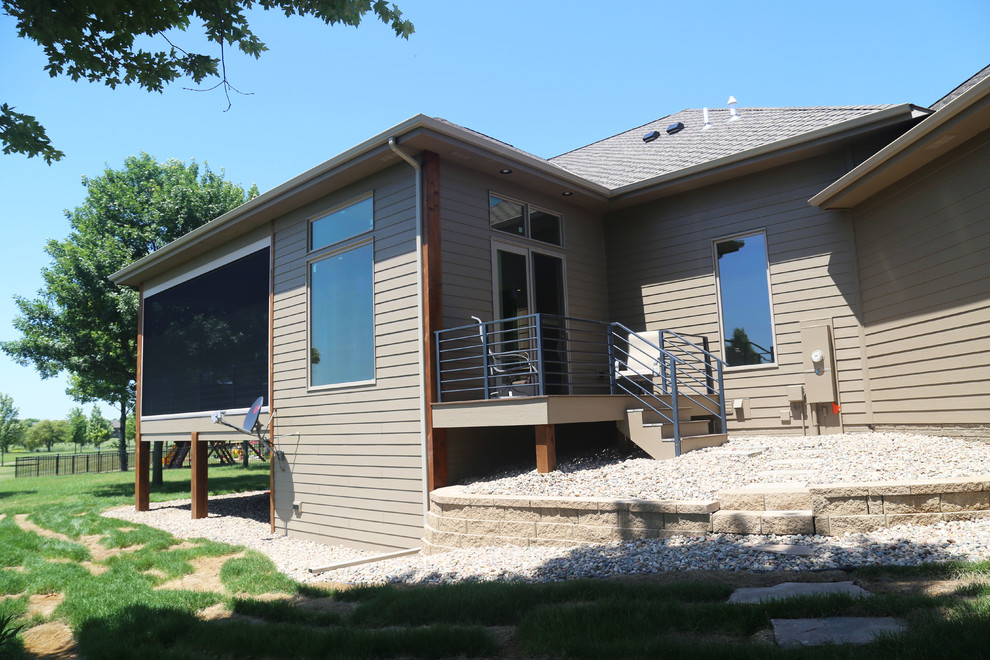 Mid-sized transitional backyard deck photo with a roof extension
