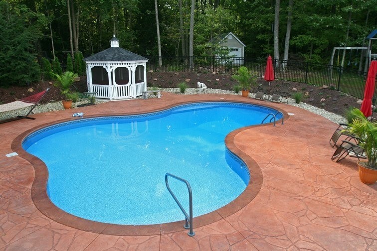 Pool - stamped concrete and custom-shaped pool idea in Boston
