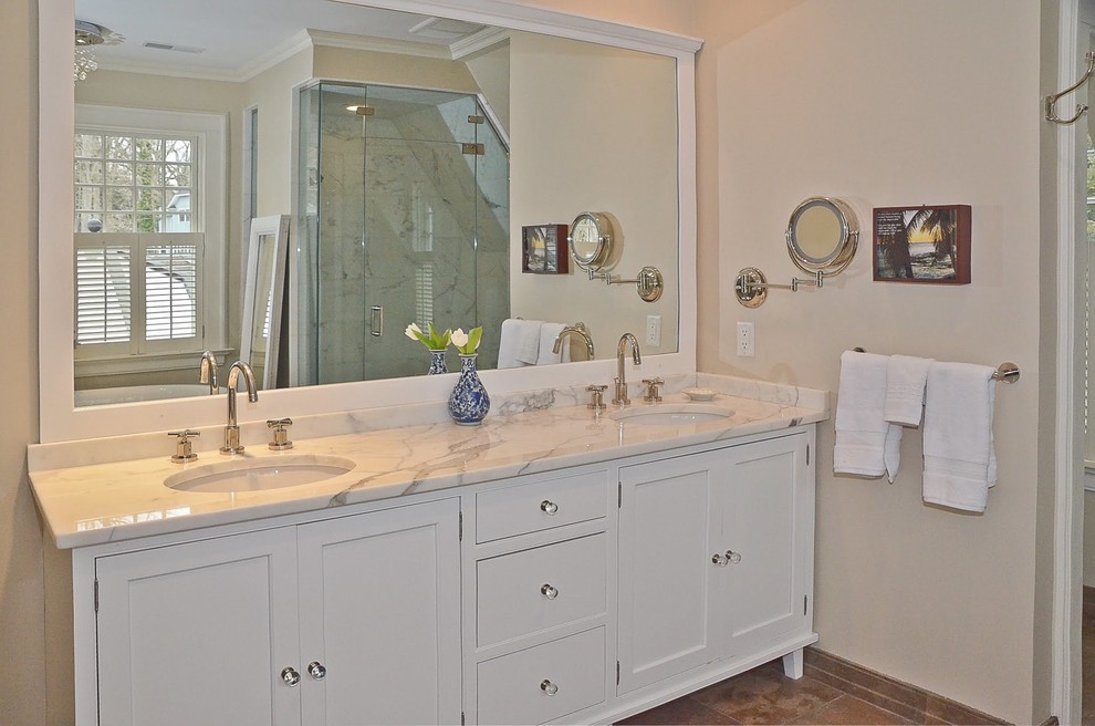 Inspiration for a mid-sized transitional master bathroom in Orange County with shaker cabinets, white cabinets, a freestanding tub, an alcove shower, gray tile, white tile, stone slab, beige walls, ceramic floors, an undermount sink, soapstone benchtops, brown floor and a hinged shower door.