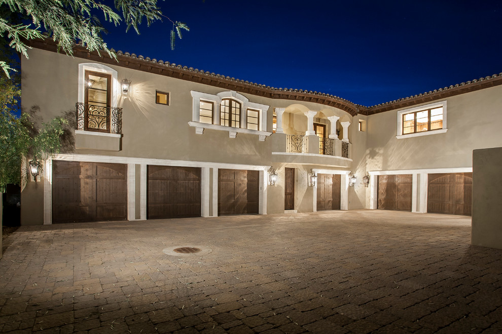This is an example of an expansive mediterranean attached four-car garage in Phoenix.