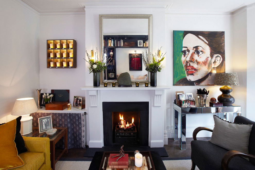 This is an example of an eclectic formal enclosed living room in London with white walls and a standard fireplace.