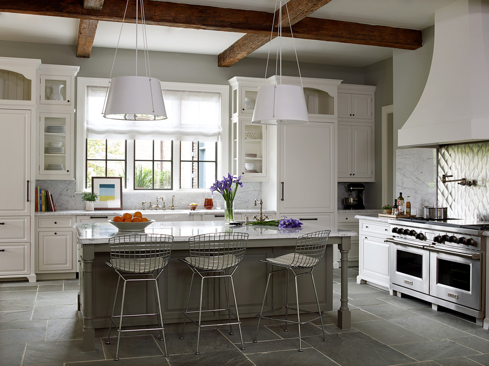 Kitchen - huge traditional slate floor and gray floor kitchen idea in Houston with a farmhouse sink, white cabinets, marble countertops, white backsplash, marble backsplash, stainless steel appliances, an island and beaded inset cabinets
