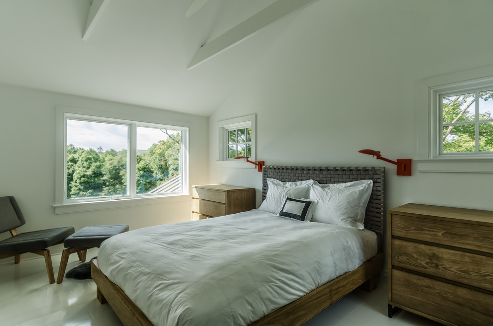 Mid-sized country bedroom in New York with white walls.