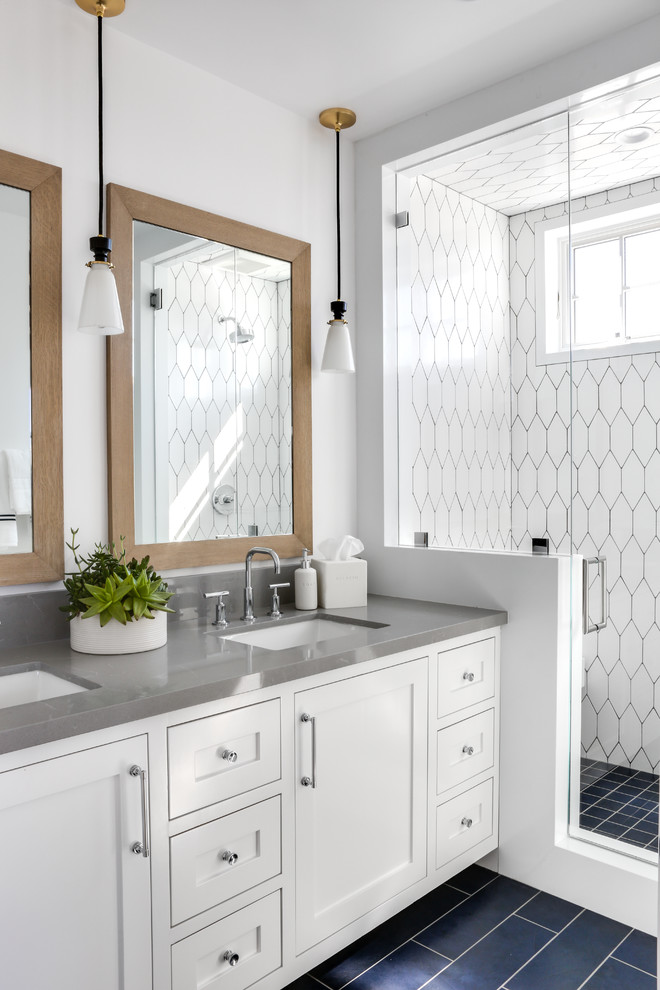 Beach style 3/4 bathroom in Los Angeles with shaker cabinets, white cabinets, white tile, white walls, an undermount sink, black floor and a hinged shower door.