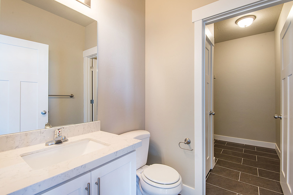Inspiration for a large arts and crafts bathroom in Salt Lake City with an undermount sink, shaker cabinets, white cabinets, engineered quartz benchtops, a one-piece toilet, gray tile, ceramic tile and grey walls.