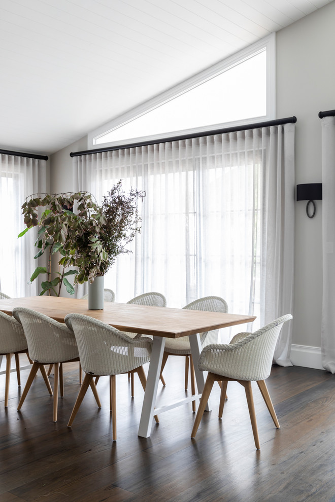 Inspiration for a transitional dining room in Sydney with grey walls, medium hardwood floors and brown floor.