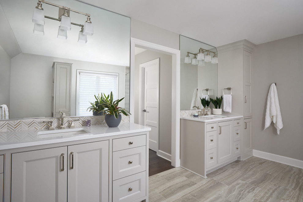 This is an example of a large transitional master bathroom in Grand Rapids with recessed-panel cabinets, grey cabinets, ceramic floors, an undermount sink, engineered quartz benchtops, grey floor, white benchtops, a double vanity and a built-in vanity.