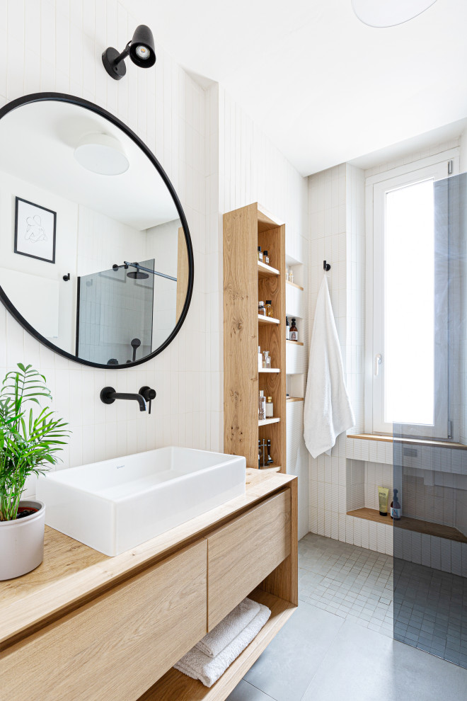Design ideas for a small scandinavian 3/4 bathroom in Milan with flat-panel cabinets, light wood cabinets, a curbless shower, a wall-mount toilet, white tile, matchstick tile, white walls, concrete floors, a vessel sink, wood benchtops, grey floor, an open shower, a single vanity, a floating vanity and recessed.