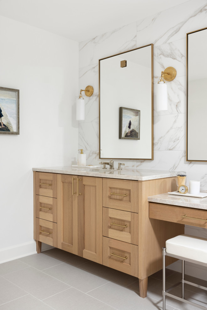 This is an example of a large beach style master bathroom in Portland with recessed-panel cabinets, medium wood cabinets, a corner shower, a bidet, white tile, porcelain tile, white walls, porcelain floors, an undermount sink, quartzite benchtops, beige floor, a hinged shower door, beige benchtops, a niche, a double vanity and a built-in vanity.