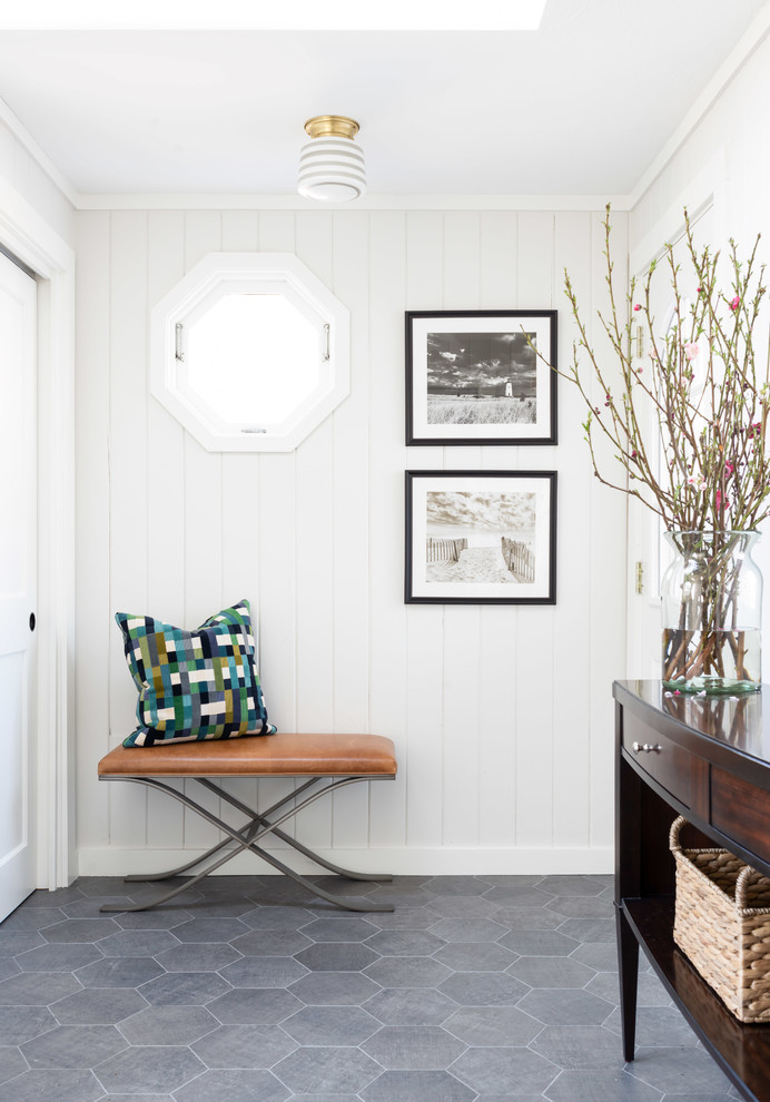 Design ideas for a beach style foyer in Boston with white walls, porcelain floors and grey floor.