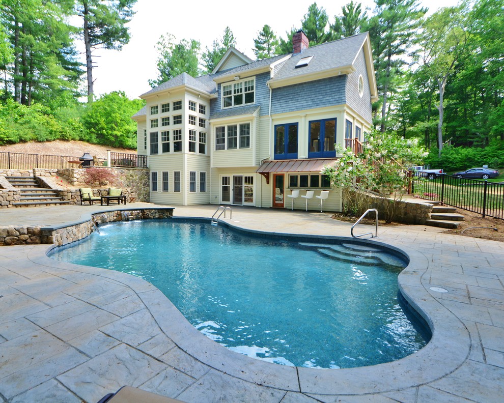 This is an example of a transitional side yard custom-shaped pool in Boston with a pool house.