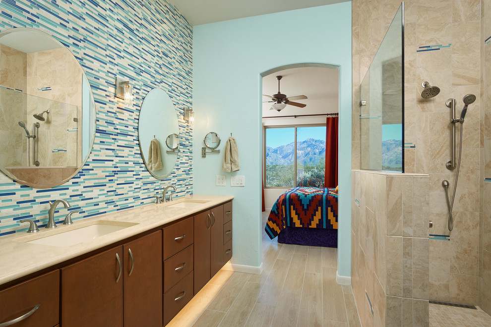 Inspiration for a large contemporary master bathroom in Other with brown cabinets, an open shower, blue tile, blue walls, porcelain floors, an undermount sink, engineered quartz benchtops, beige floor, glass tile, an open shower, beige benchtops and flat-panel cabinets.