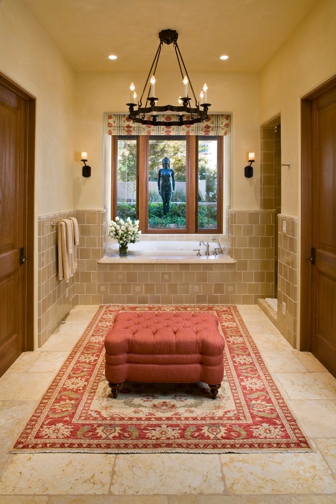 Inspiration for a country bathroom in Other with a drop-in tub and brown tile.