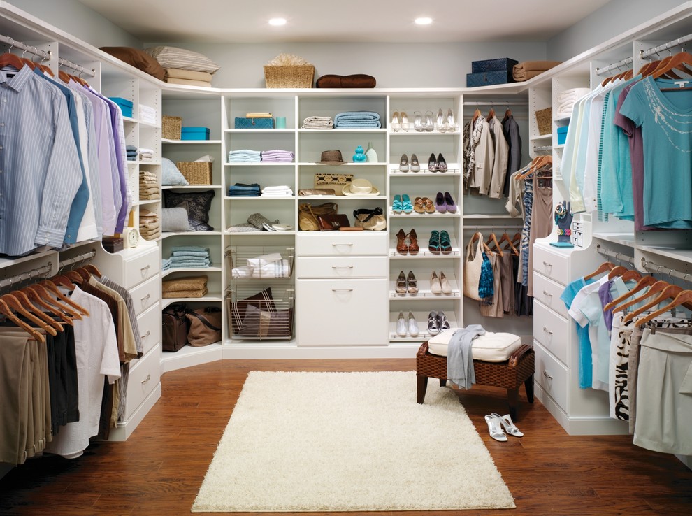 Inspiration for a large transitional gender-neutral walk-in wardrobe in Philadelphia with white cabinets, dark hardwood floors, brown floor and flat-panel cabinets.