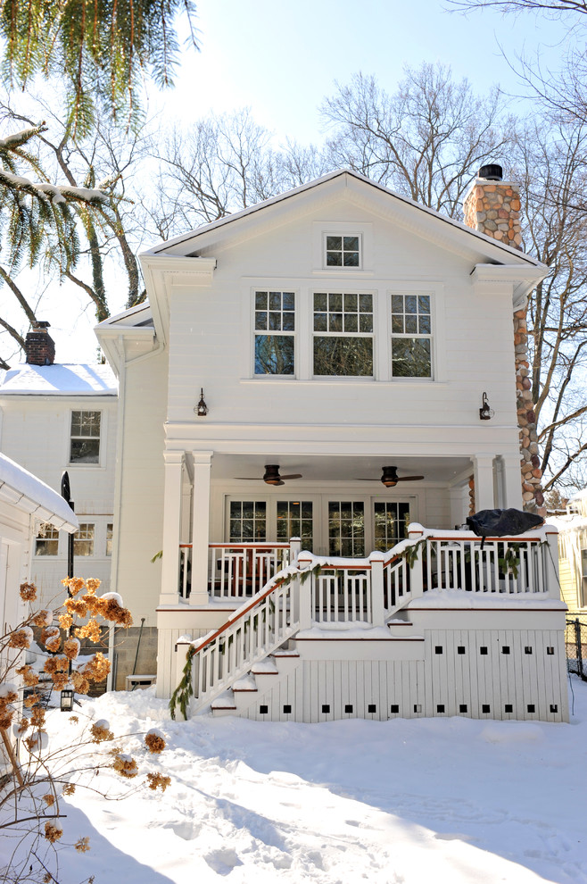 Large traditional two-storey white exterior in Cleveland with vinyl siding and a gable roof.