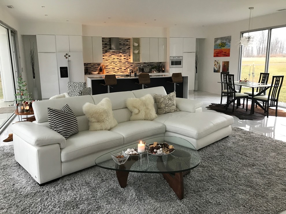 Design ideas for a mid-sized contemporary open concept family room in Indianapolis with beige walls, porcelain floors, a standard fireplace, a tile fireplace surround and a wall-mounted tv.
