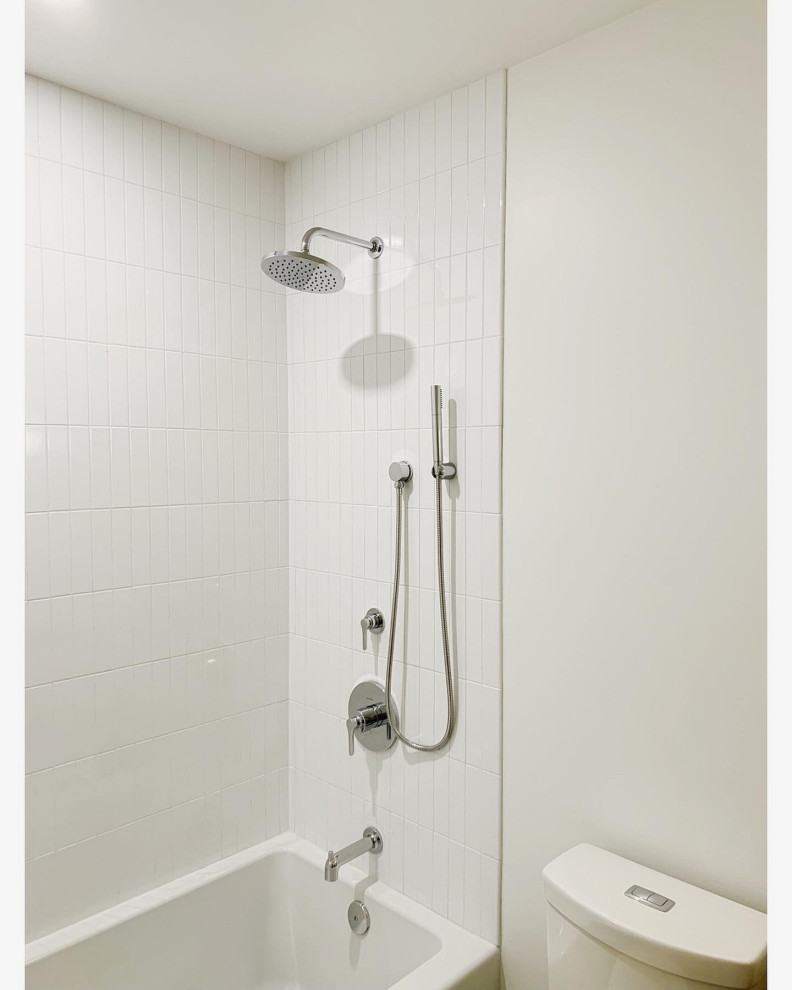 Photo of a small contemporary bathroom in Philadelphia with flat-panel cabinets, dark wood cabinets, an alcove tub, an alcove shower, a two-piece toilet, white tile, ceramic tile, white walls, terrazzo floors, a drop-in sink, engineered quartz benchtops, grey floor, a hinged shower door and white benchtops.
