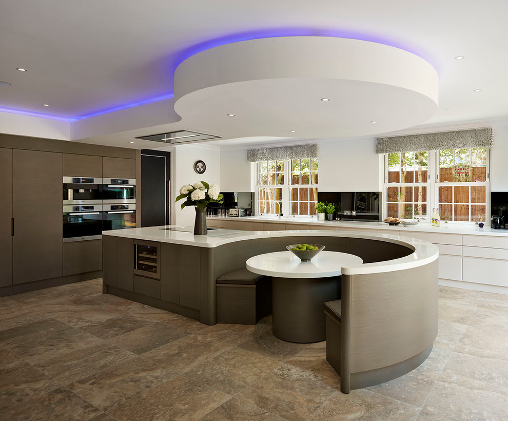 Design ideas for an expansive contemporary open plan kitchen in Other with a drop-in sink, solid surface benchtops, black appliances and with island.