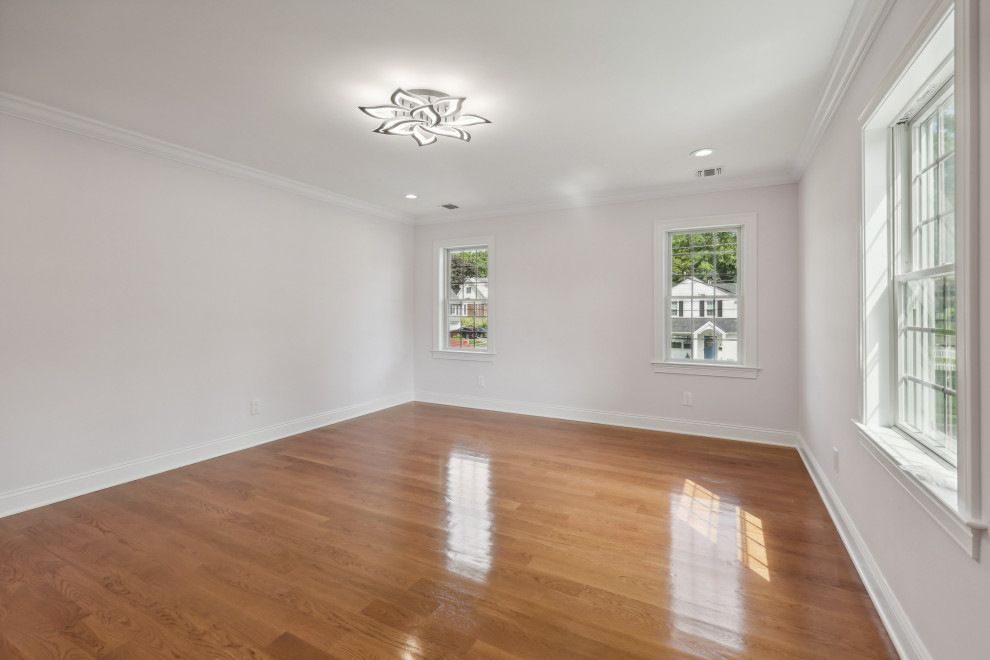 Bedroom in Fair Lawn, NJ by WA Construct. Three divided-light double-hung window