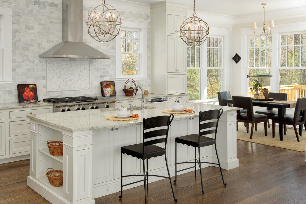 Inspiration for a traditional eat-in kitchen in Atlanta with an undermount sink, recessed-panel cabinets, white cabinets, grey splashback, stainless steel appliances, medium hardwood floors, with island and stone tile splashback.