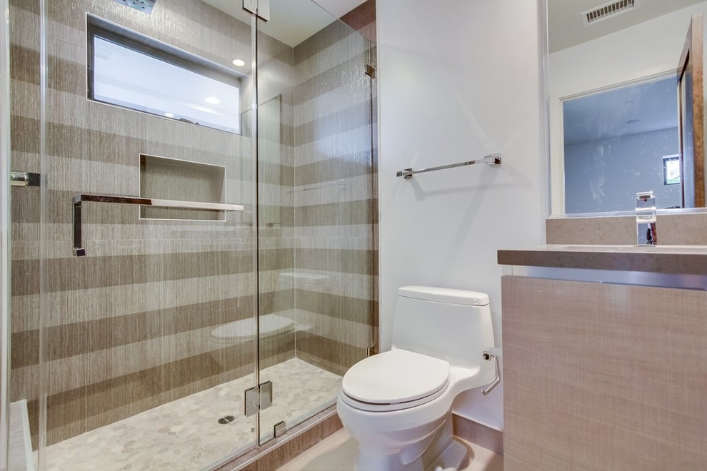 Inspiration for a mid-sized contemporary bathroom in Los Angeles with an undermount sink, flat-panel cabinets, light wood cabinets, engineered quartz benchtops, a corner shower, a one-piece toilet, brown tile, ceramic tile and white walls.