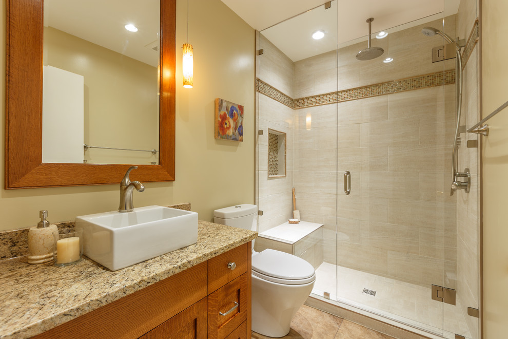 Design ideas for a small contemporary master bathroom in Vancouver with a vessel sink, shaker cabinets, medium wood cabinets, granite benchtops, an alcove shower, a two-piece toilet, beige tile, porcelain tile, yellow walls and porcelain floors.