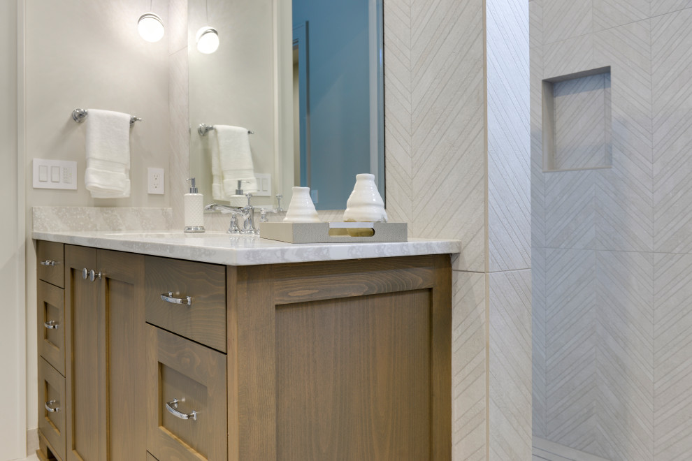 Mid-sized modern master bathroom in Portland with shaker cabinets, brown cabinets, a curbless shower, a one-piece toilet, gray tile, porcelain tile, grey walls, medium hardwood floors, an undermount sink, engineered quartz benchtops, grey floor, an open shower and white benchtops.