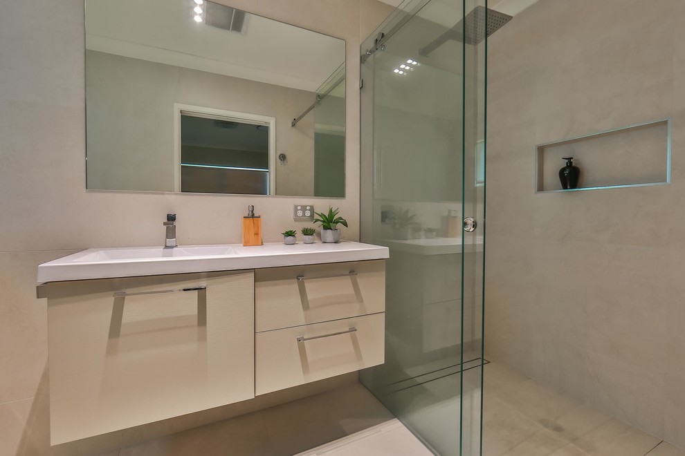 Photo of a mid-sized contemporary bathroom in Brisbane with a curbless shower, ceramic tile, beige walls, ceramic floors, beige floor, a sliding shower screen and white benchtops.