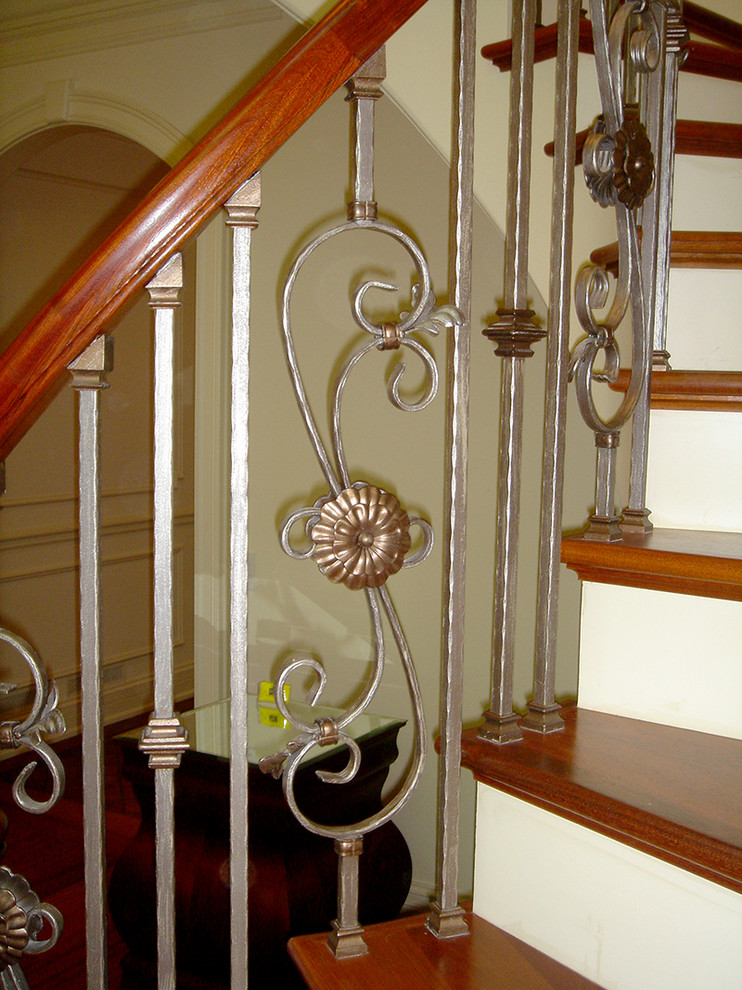 Mid-sized traditional wood curved staircase in Chicago with painted wood risers.