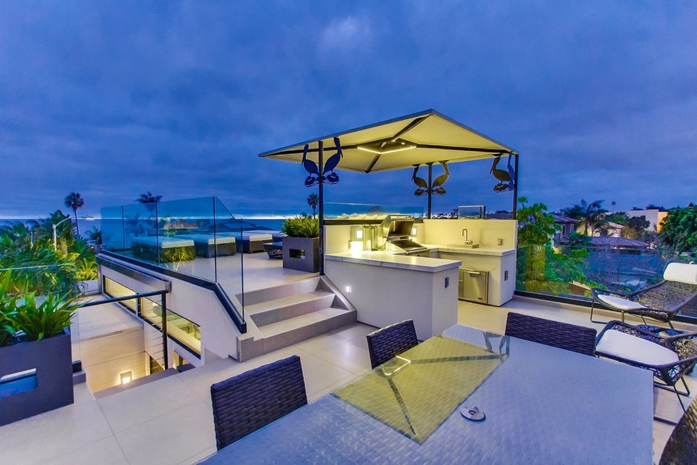 Huge island style rooftop outdoor kitchen deck photo in San Diego with no cover