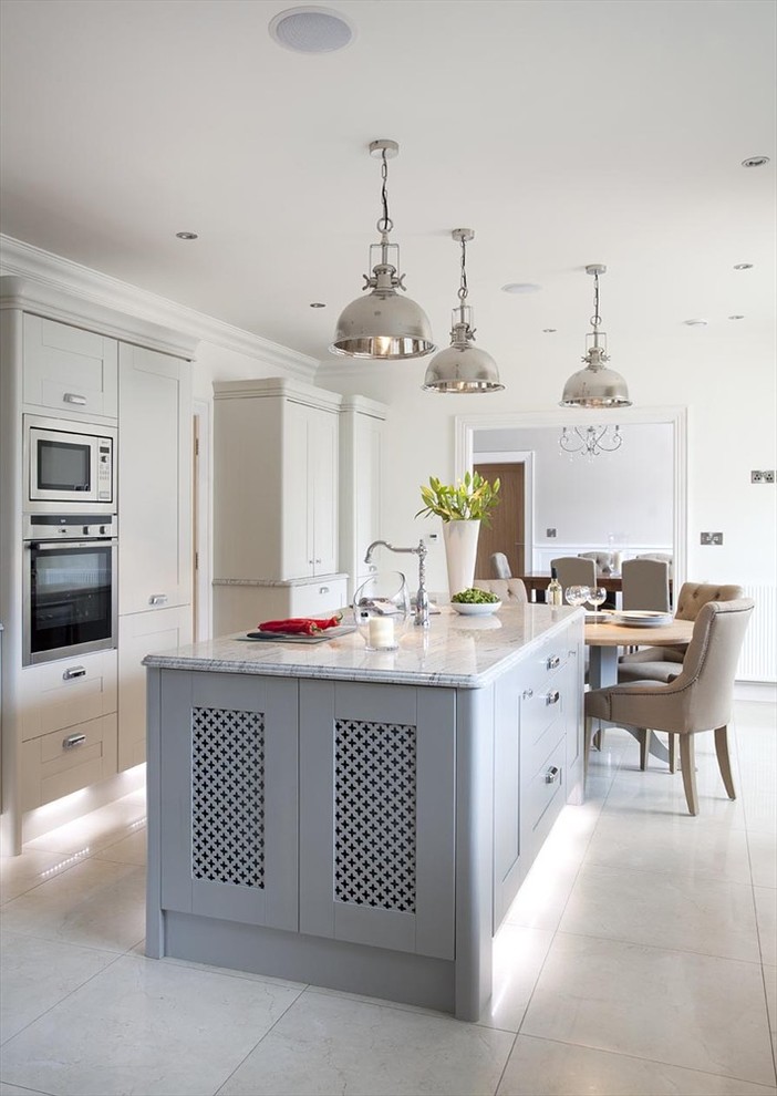 Photo of a transitional eat-in kitchen in Belfast with shaker cabinets, grey cabinets and stainless steel appliances.