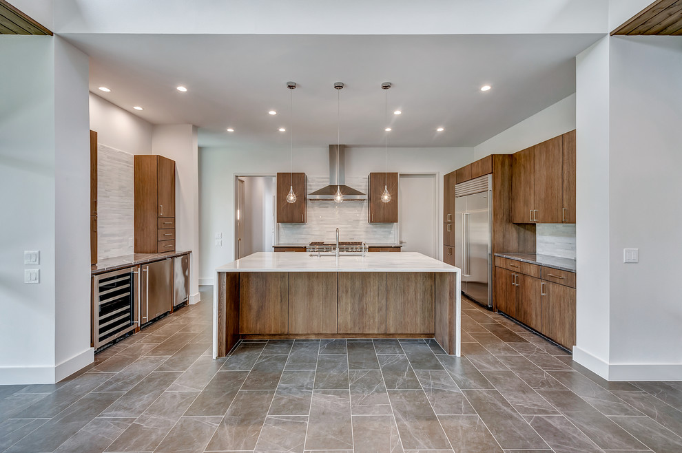 Inspiration for a modern porcelain tile and gray floor eat-in kitchen remodel in Dallas with an undermount sink, flat-panel cabinets, medium tone wood cabinets, quartz countertops, white backsplash, marble backsplash, stainless steel appliances and an island