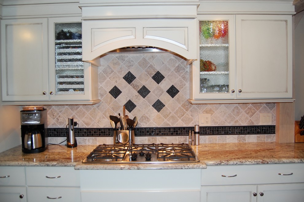 Example of a mid-sized transitional u-shaped medium tone wood floor open concept kitchen design in Chicago with an undermount sink, flat-panel cabinets, dark wood cabinets, granite countertops, beige backsplash, stone tile backsplash, stainless steel appliances and a peninsula