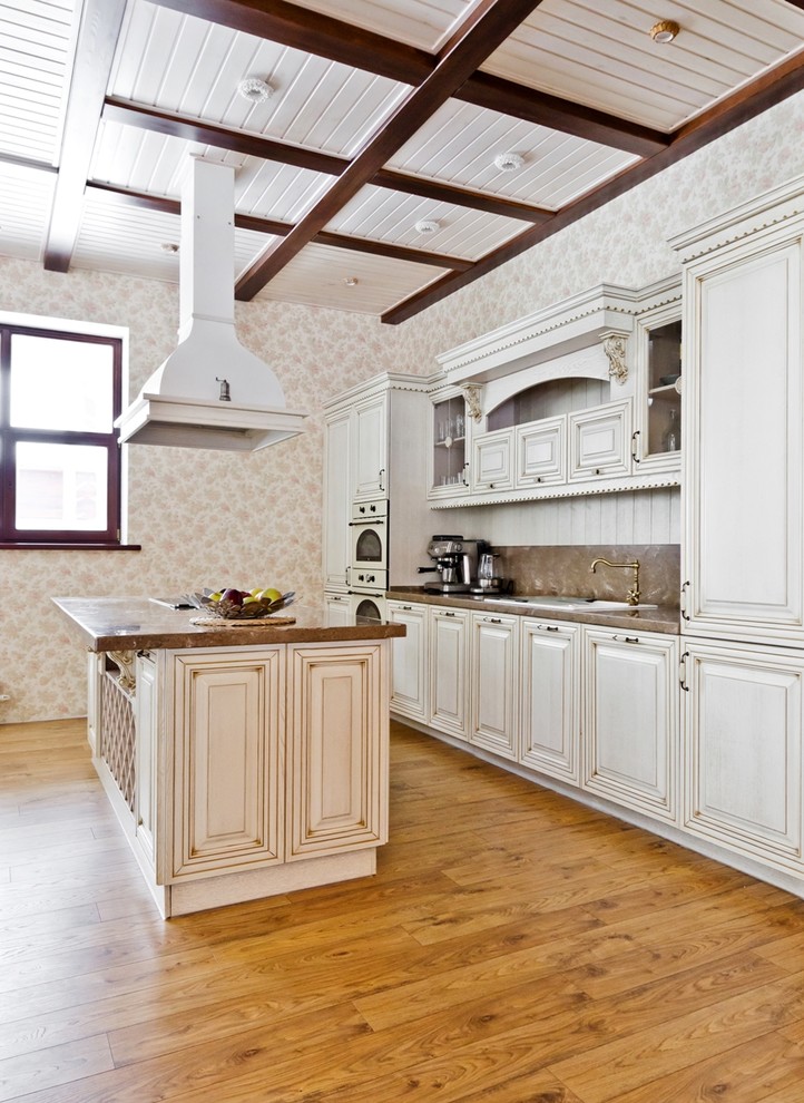 Design ideas for a large traditional galley eat-in kitchen in Other with a drop-in sink, beaded inset cabinets, white cabinets, solid surface benchtops and with island.