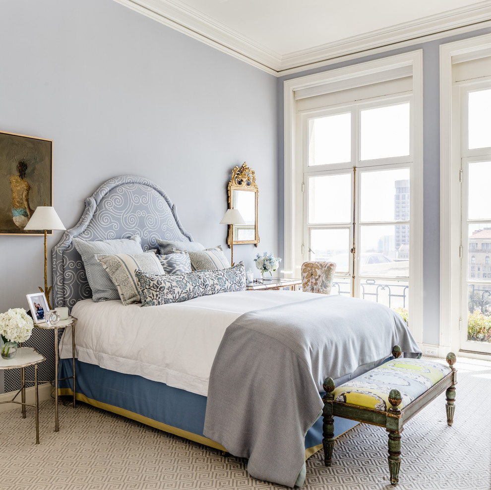This is an example of a large transitional guest bedroom in San Francisco with blue walls, carpet, no fireplace and beige floor.