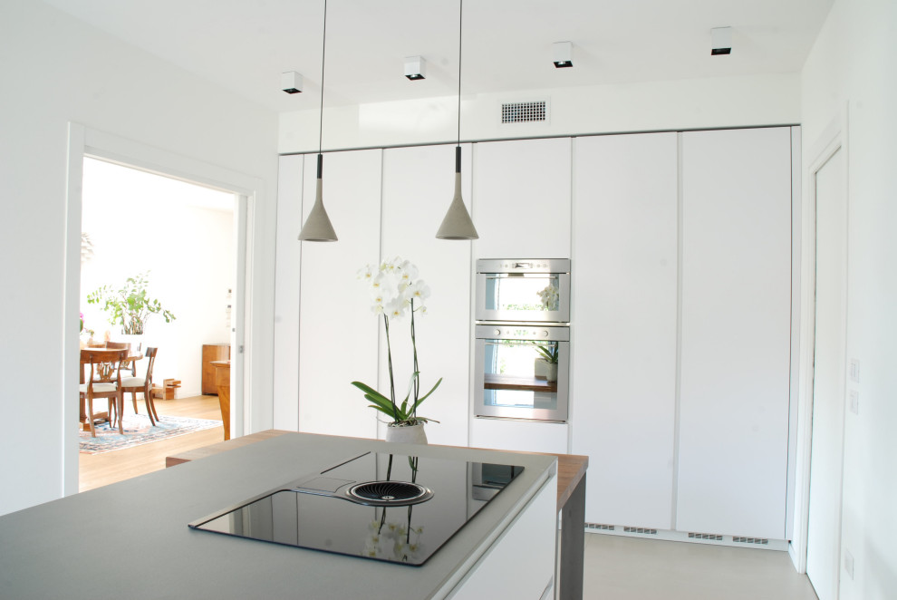 Inspiration for a large contemporary single-wall separate kitchen in Other with a single-bowl sink, beaded inset cabinets, white cabinets, concrete benchtops, grey splashback, stainless steel appliances, porcelain floors, a peninsula, beige floor and grey benchtop.