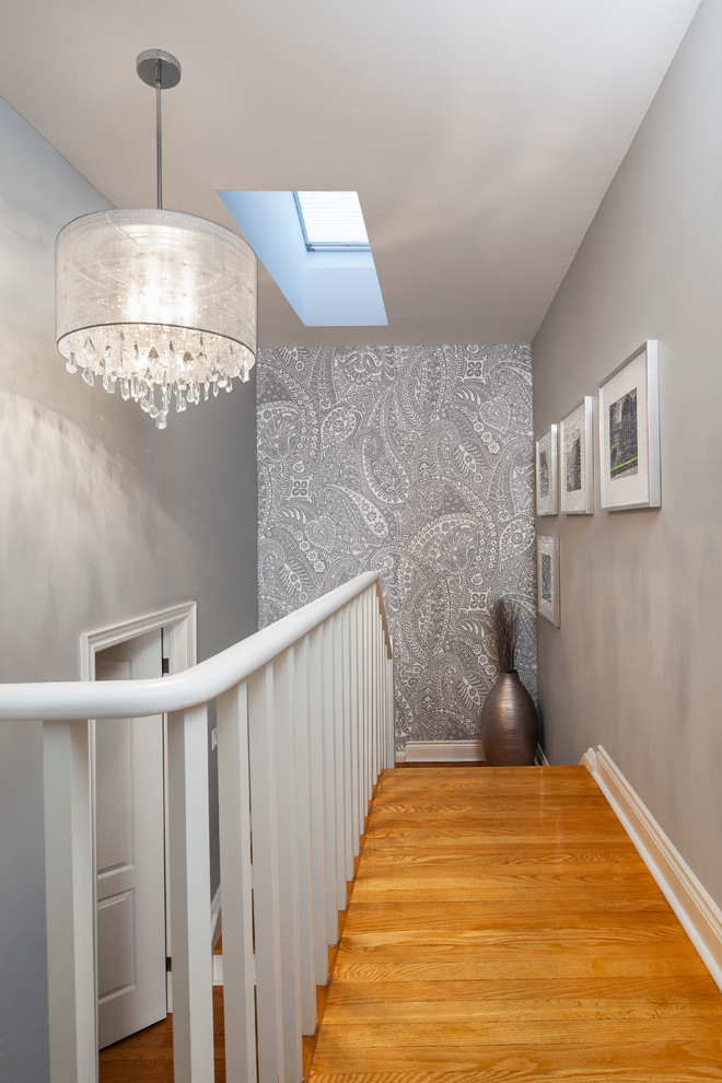 This is an example of a mid-sized transitional wood u-shaped staircase in Toronto with wood risers.