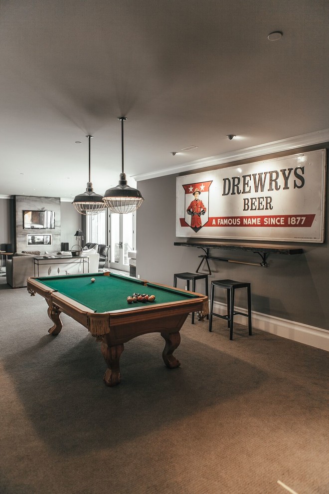 Inspiration for a large industrial open concept family room in Vancouver with a game room, grey walls, carpet, a wall-mounted tv and brown floor.
