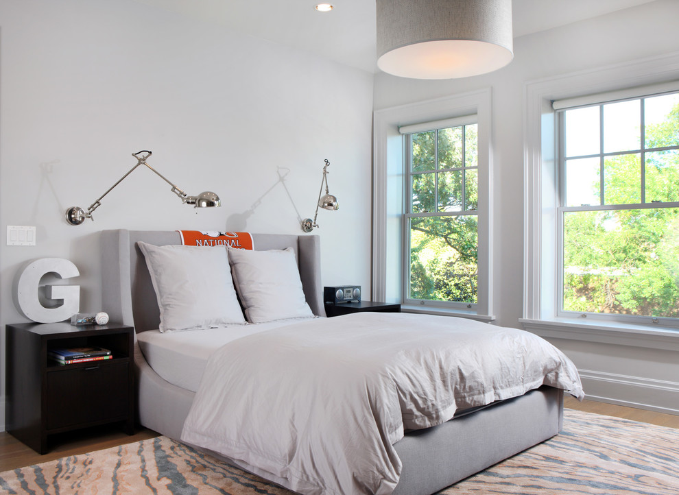 This is an example of a contemporary bedroom in Chicago with white walls.